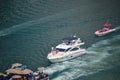 Dubai, UAE 2020: Tourist enjoying ride in luxury boats in marina area. Huge Blue color Yacht sailing in man made lake