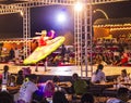 Dubai, UAE - 11.06.2022 - Traditional dancer performs in the front of the crowd during desert safari. Safari