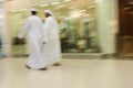 Dubai UAE Two men traditionally dressed in dishdashs and gutras white robes and headdresses. Royalty Free Stock Photo