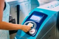 Dubai, UAE, United Arab Emirates - May 28, 2021: Applying a gold card at the turnstile in the Dubai metro. Women