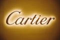 Dubai, UAE, United Arab Emirates - May 28, 2021: Close golden logotype Cartier (jeweler) Brand at wall of store