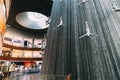 Dubai, UAE, United Arab Emirates - May 22, 2021: View of waterfall with figures of divers in the Dubai Mall. Fountain in Royalty Free Stock Photo