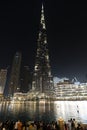 people tourists are waiting for a fountain show in front of a skyscraper Burj Khalifa at night Royalty Free Stock Photo