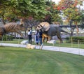 Dubai,UAE - 05.11.2021 -Visitors inspecting dinosaurs replicas exhibits at dinosaur park. outdoor