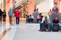 DUBAI, UNITED ARAB EMIRATES - APRIL 25, 2018: Bored men waiting for women to finish shopping, interior shopping Mall.