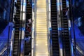 Dubai, United Arab Emirates - commuters ride bank of escalators inside Dubai Metro Station. Futuristic BurJuman stop interior.