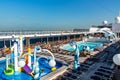 Dubai, United Arab Emirates - December 12, 2018: cruise ship upper deck with swimming pool and resting passengers