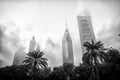 Dubai, United Arab Emirates - December 23, 2017: palm trees and towers on cloudy sky. Skyline with tropical garden in Royalty Free Stock Photo