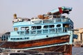 The reverse side of the capital seaport. A small wooden  private no name merchant ships and boats  with old cars against  of urban Royalty Free Stock Photo