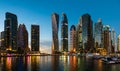 Dubai, United Arab Emirates - February 14, 2019: Dubai marina modern skyscrapers and luxury yachts at blue hour