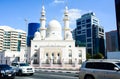 DUBAI, UNITED ARAB EMIRATES - FEBRUARY 1, 2018: Mosque near Dubai Creek surrounded by modern buildings and busy street Royalty Free Stock Photo