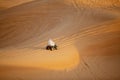 Emirati ride a Quad bike across the sand dunes at a desert safari park near Dubai