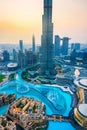 Dubai, United Arab Emirates - July 5, 2019: Burj khalifa rising above Dubai mall and fountain surrounded by modern buildings top Royalty Free Stock Photo