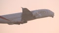 DUBAI, UNITED ARAB EMIRATES - MARCH 10, 2017: Passenger airplane flies across blue sky. Plane taking off. Aircraft