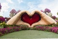 Two giant hands folded in the shape of a heart in botanical Dubai Miracle Garden with different floral fairy-tale themes in Dubai