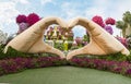 Two giant hands folded in the shape of a heart in botanical Dubai Miracle Garden with different floral fairy-tale themes in Dubai