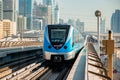 Dubai, United Arab Emirates - November 06, 2021: Dubai metro train on rails at background of skyscrapers. Famous outdoor subway Royalty Free Stock Photo