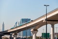 Dubai, United Arab Emirates - November 06, 2021: Dubai metro train on rails at background of skyscrapers. Famous outdoor subway Royalty Free Stock Photo