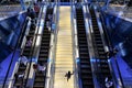 Dubai, United Arab Emirates - people ride escalators and climb stairs inside the Dubai Metro Station. Futuristic interior. Royalty Free Stock Photo