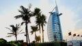 DUBAI, UNITED ARAB EMIRATES, UAE - NOVEMBER 20, 2017: Hotel Burj al Arab , at sunset, palms are seen, flags are Royalty Free Stock Photo