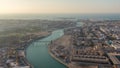 Dubai water canal with footbridge during sunset aerial timelapse from Downtown skyscrapers rooftop