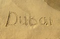 Dubai word on beach sand. Dubai city letters are written on the sand