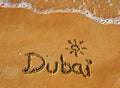 Dubai word on sand beach background