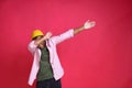 Dubbing african american young man wearing pink shirt and yellow hat isolated on red background. Happy trendy african young man in Royalty Free Stock Photo