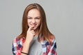 Dubious teen girl thinking biting her finger