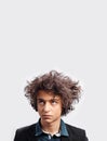 Portrait of dubious young man with awesome hairdo, with headphones, looking pensive, isolated on white background. Royalty Free Stock Photo