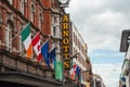 Dublin city center, Ireland - 07.06.2021: Arnotts sign on Henry street with flags of Ireland, Canada, Euro union and Dublin