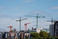 Dublin city center, Ireland - 07.06.2021: Six tall construction cranes over town buildings. Growth and development of town center
