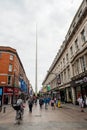 Dublin city center, Ireland - 07.06.2021: View on Spire from busy Henry street. Vertical image, people walking by