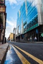 Dublin city, Ireland - 02.10.2021: Small narrow street in old town with modern glass building with reflection of old brick Royalty Free Stock Photo