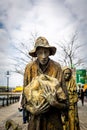 PPblic art of history and poverty. Steel sculptures of worn people on a pedestrian walkway in Dublin.