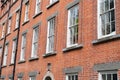 Red brick historical building known as Rubrics rows of double hung windows in brick facade now used for student accommodation four