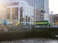 Dublin, Ireland - 20.12.2022: Busy city bus traffic by river Liffey in Irish capital center