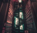 DUBLIN, IRELAND, DECEMBER 21, 2018: Magnificent spiral staircase in The Long Room in the Trinity College Library, home to The Book