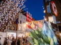 Dublin, Ireland - 20.12.2022: Flowers bouquet in focus and Decorated and illuminated Grafton street in the Irish capital out of