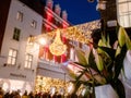 Dublin, Ireland - 20.12.2022: Flowers bouquet in focus and Decorated and illuminated Grafton street in the Irish capital out of