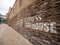 Dublin, Ireland - 07.12.2023: Guinness sign on a wall of a Guinness brewery and museum. Popular travel area and capital landmark