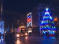 Dublin, Ireland 11.27.2022: Illuminated Christmas tree by The Spiro and busy city traffic. Night shot. Selective focus Royalty Free Stock Photo