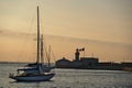 Beautiful evening view of sailboats mooring near red East Pier lighthouse with Irish flag in Dun Laoghaire harbor Royalty Free Stock Photo