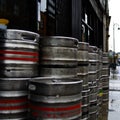 Dublin, Ireland - May 17th 2022: Aluminium beer kegs by Guinness Brewery stacked in front of a pub in Dublin