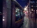 Dublin, Ireland - 12.11.2021: Night scene. Luas rail service tram moving to town center. Motion blur. City life Royalty Free Stock Photo
