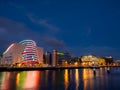 Dublin, Ireland -01.08.2023: Night shot of river Liffey and The Convention Centre Dublin illuminated with Irish flag color lights