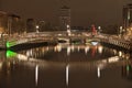 Dublin, Ireland - November 13, 2021: Beautiful evening view of River Liffey and illuminated Ha`penny Bridge Royalty Free Stock Photo