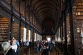 Dublin, Ireland: Trinity College, visitors in the Long Room in the Old Library Royalty Free Stock Photo