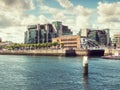 Dublin, Ireland - 07.12.2023: River Liffey and IFSC House. Warm sunny day. Cloudy sky. City center and popular tourist area Royalty Free Stock Photo