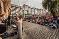 Street concert in Dublin Temple Bar with people standing by the excited buskers. Irish rock band holding a musical performance